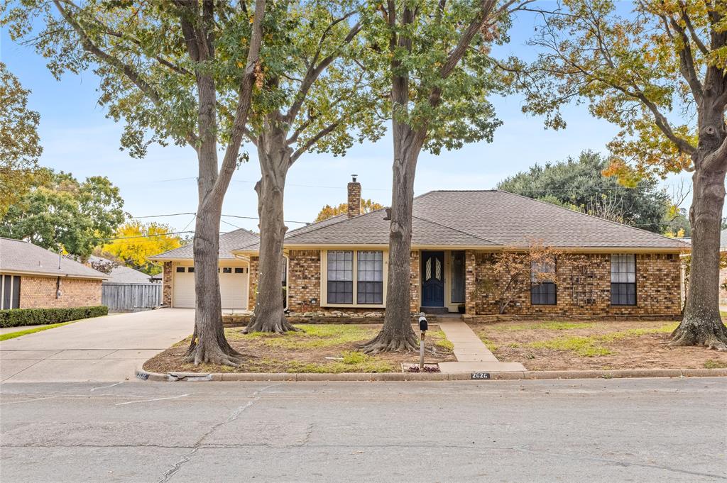 2626 Collard Road Arlington, TX 76017 - Photo 10 of 40 a front view of a house with a tree and a yard