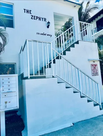 a view of staircase with white walls and a window
