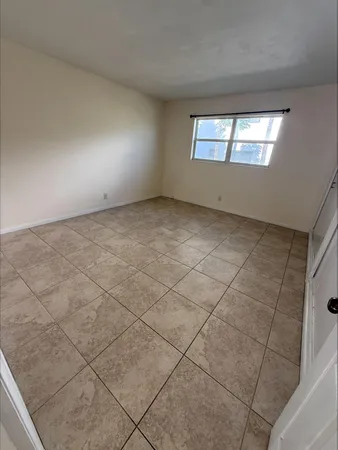 a view of an empty room with a window