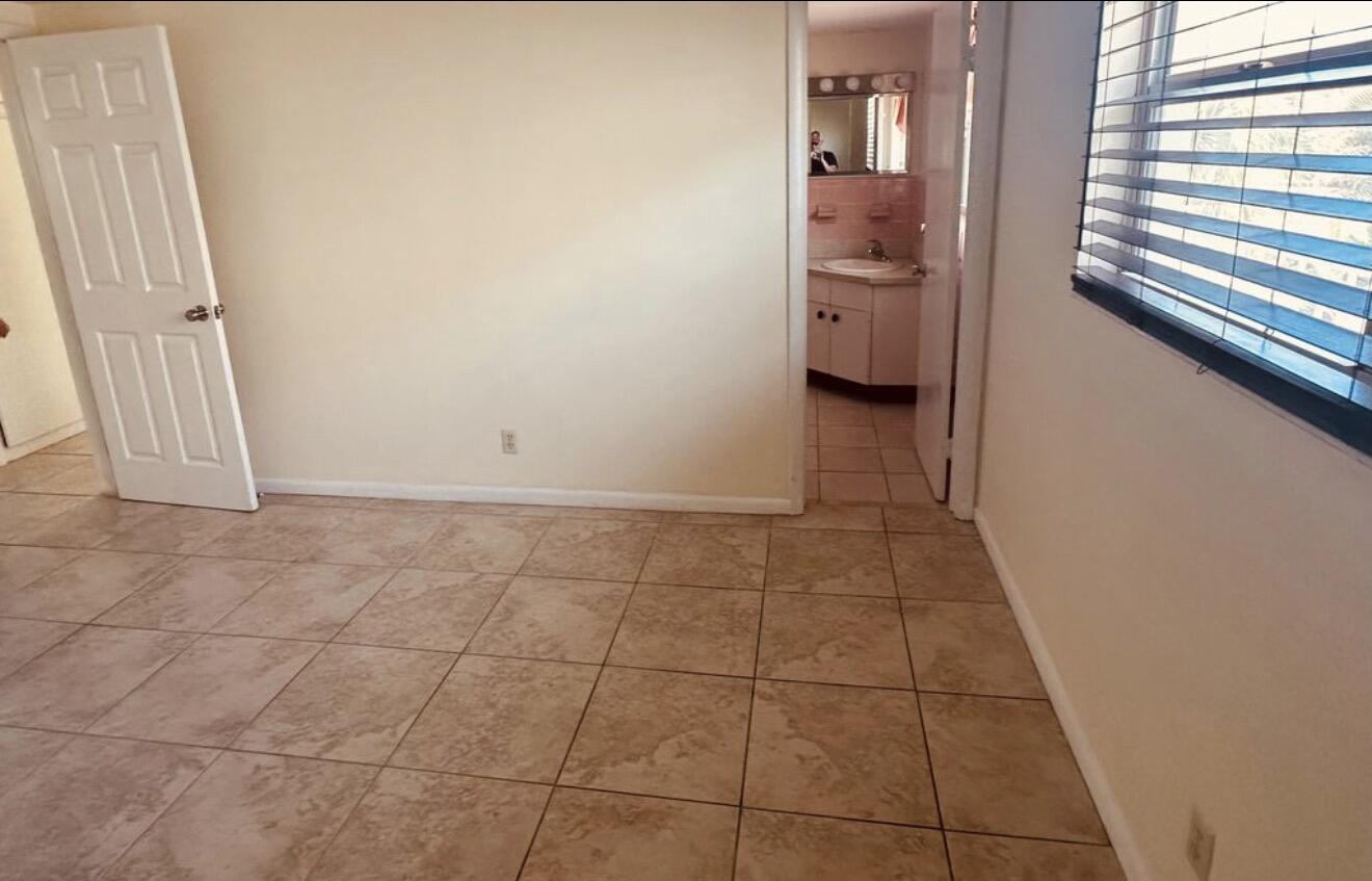 220 Inlet Way, Unit 3 Palm Beach Shores, FL 33404 - Photo 15 of 16 a bathroom with a sink a toilet and a window