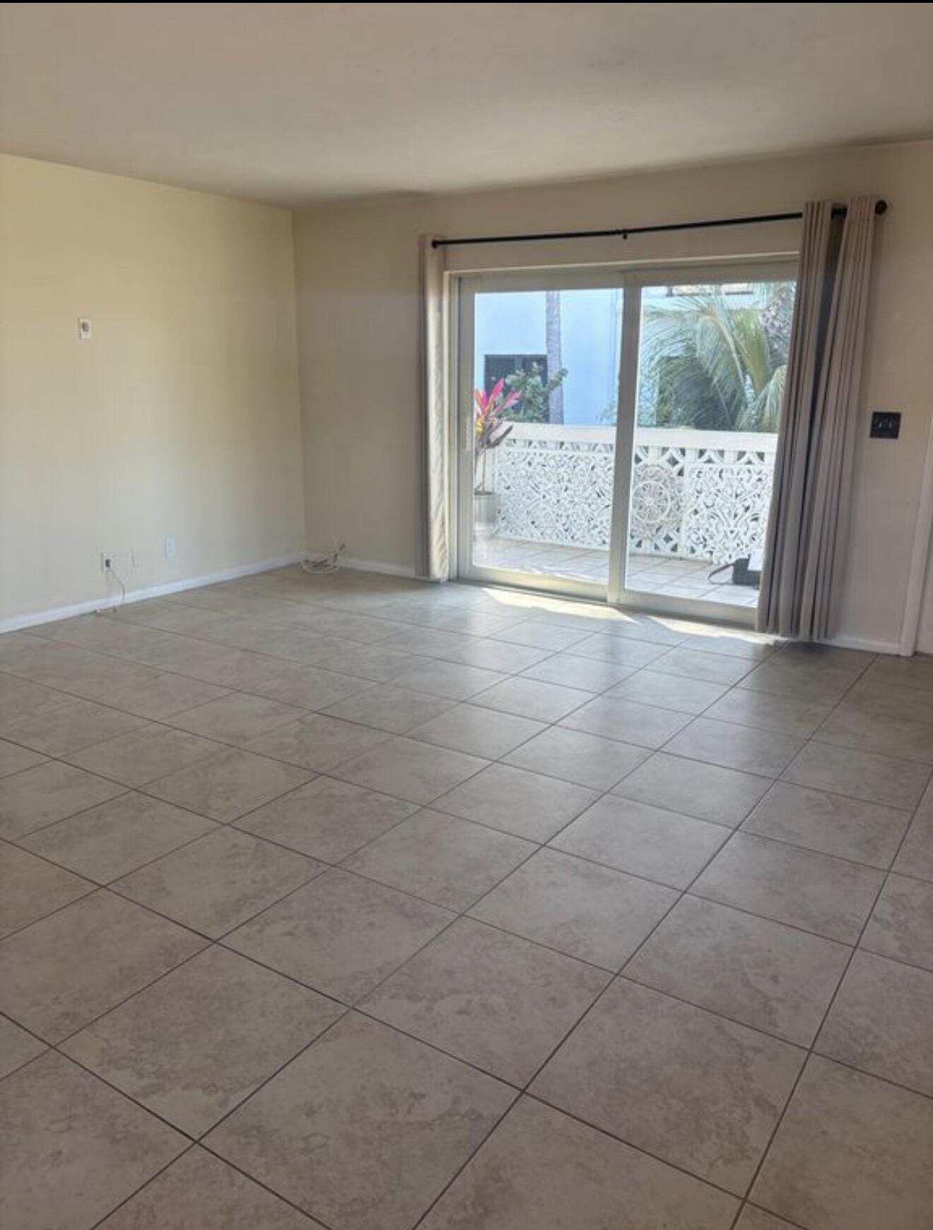 220 Inlet Way, Unit 3 Palm Beach Shores, FL 33404 - Photo 7 of 16 a view of an empty room with a fireplace and a large window