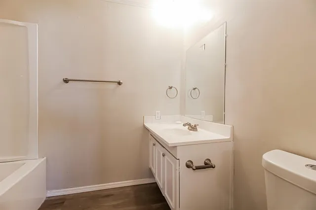 a bathroom with a sink a toilet and vanity