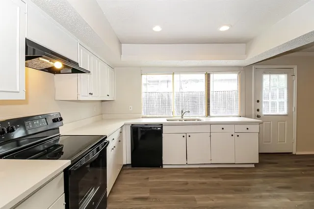 a kitchen with a sink stove and cabinets