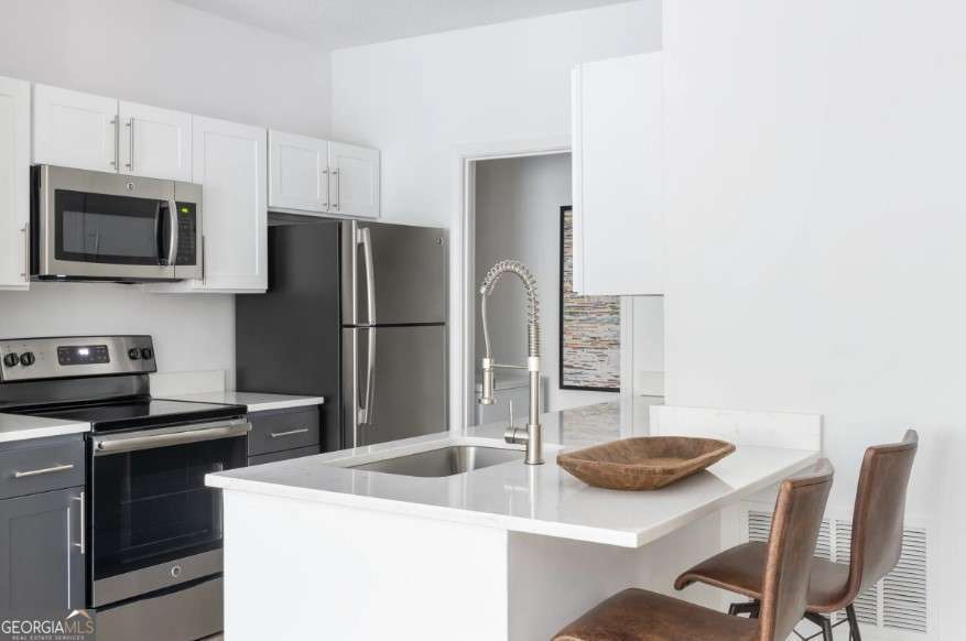 2500 Shallowford Road, Unit 4403 Atlanta, GA 30345 - Photo 3 of 20 a kitchen with a sink a stove and refrigerator
