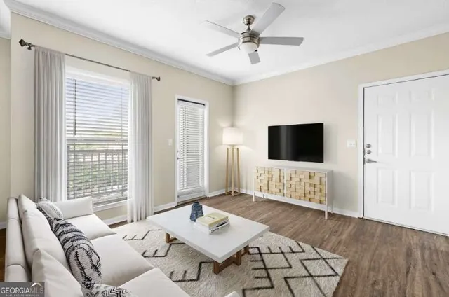 a living room with furniture and a flat screen tv