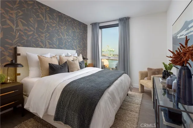 a bedroom with bed and a potted plant