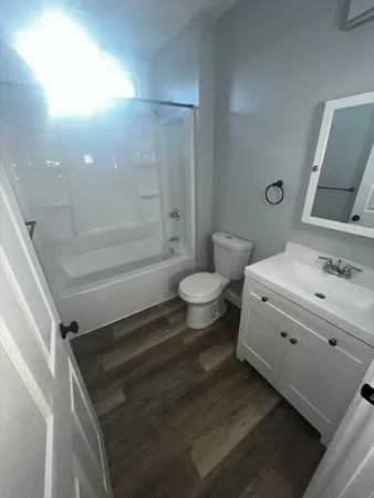 a view of empty room with kitchen and window