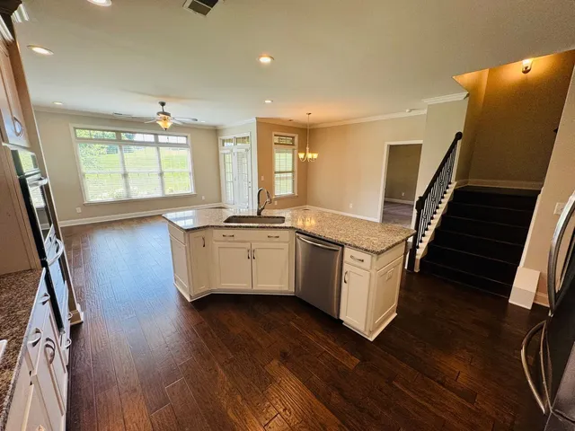 a kitchen with sink cabinets and wooden floor