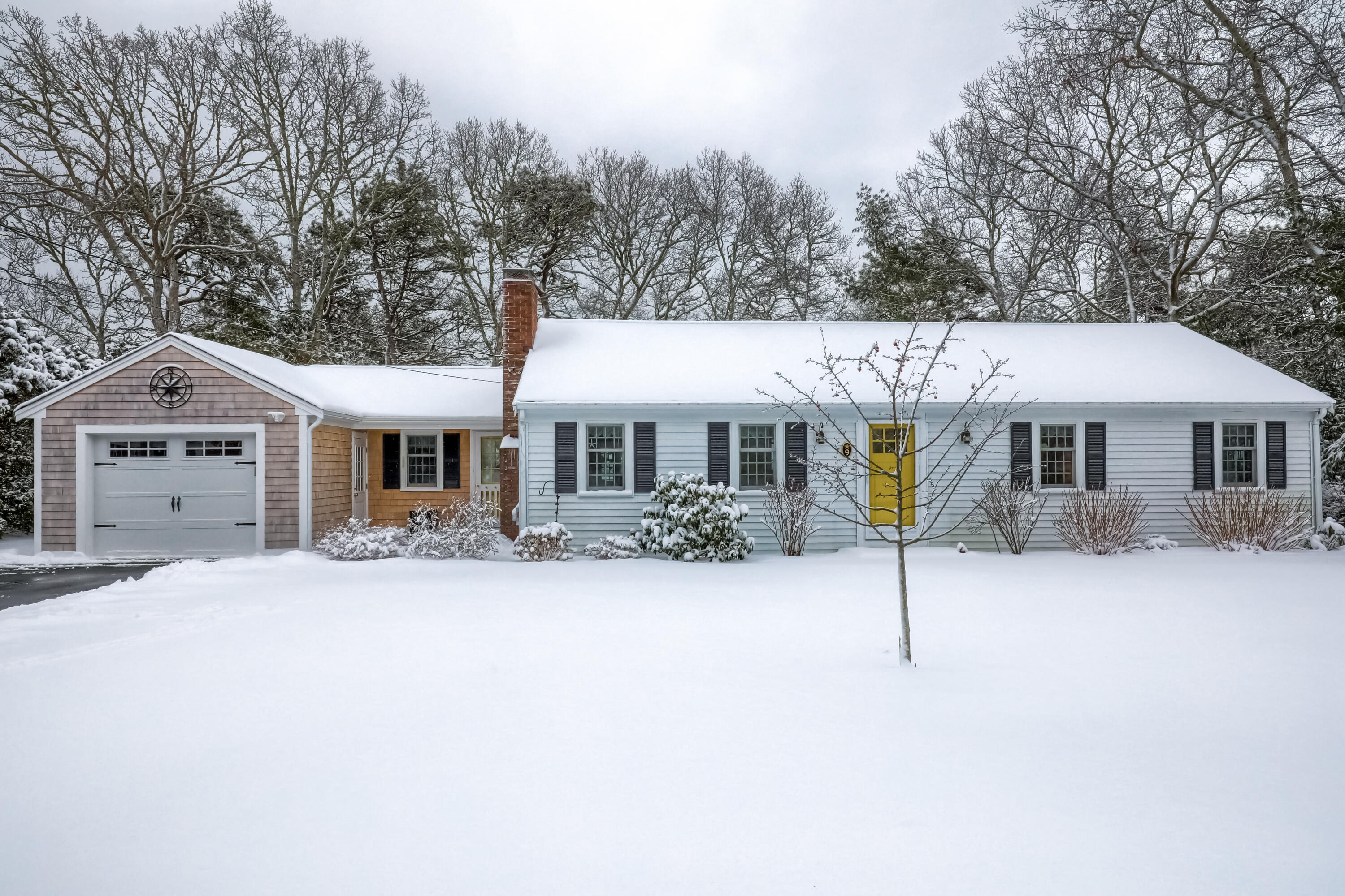 9 Captain Chase Road South Yarmouth, MA 02664 - Photo 1 of 28 a front view of a house with a yard covered in snow