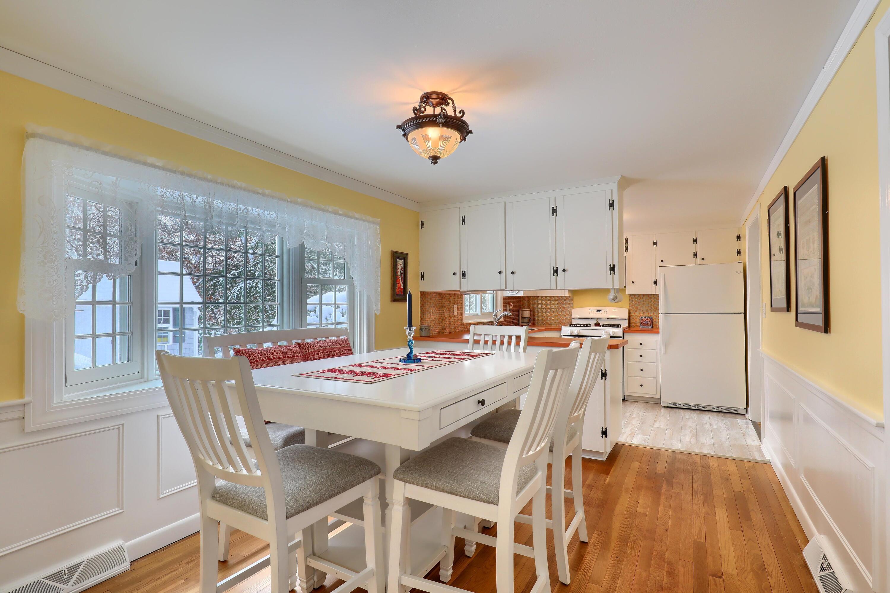 9 Captain Chase Road South Yarmouth, MA 02664 - Photo 15 of 28 a dining room with a table chairs and a kitchen view