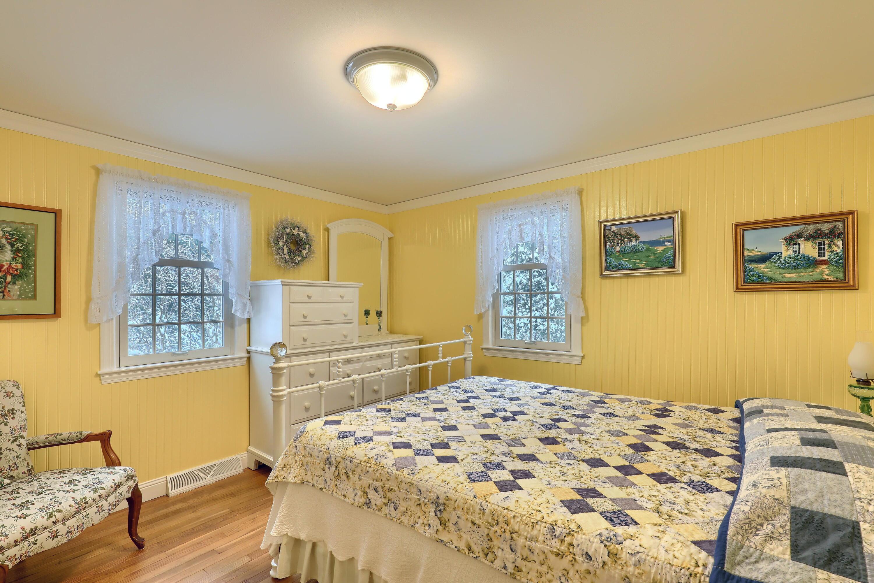 9 Captain Chase Road South Yarmouth, MA 02664 - Photo 21 of 28 a bedroom with a bed and a dresser with mirror