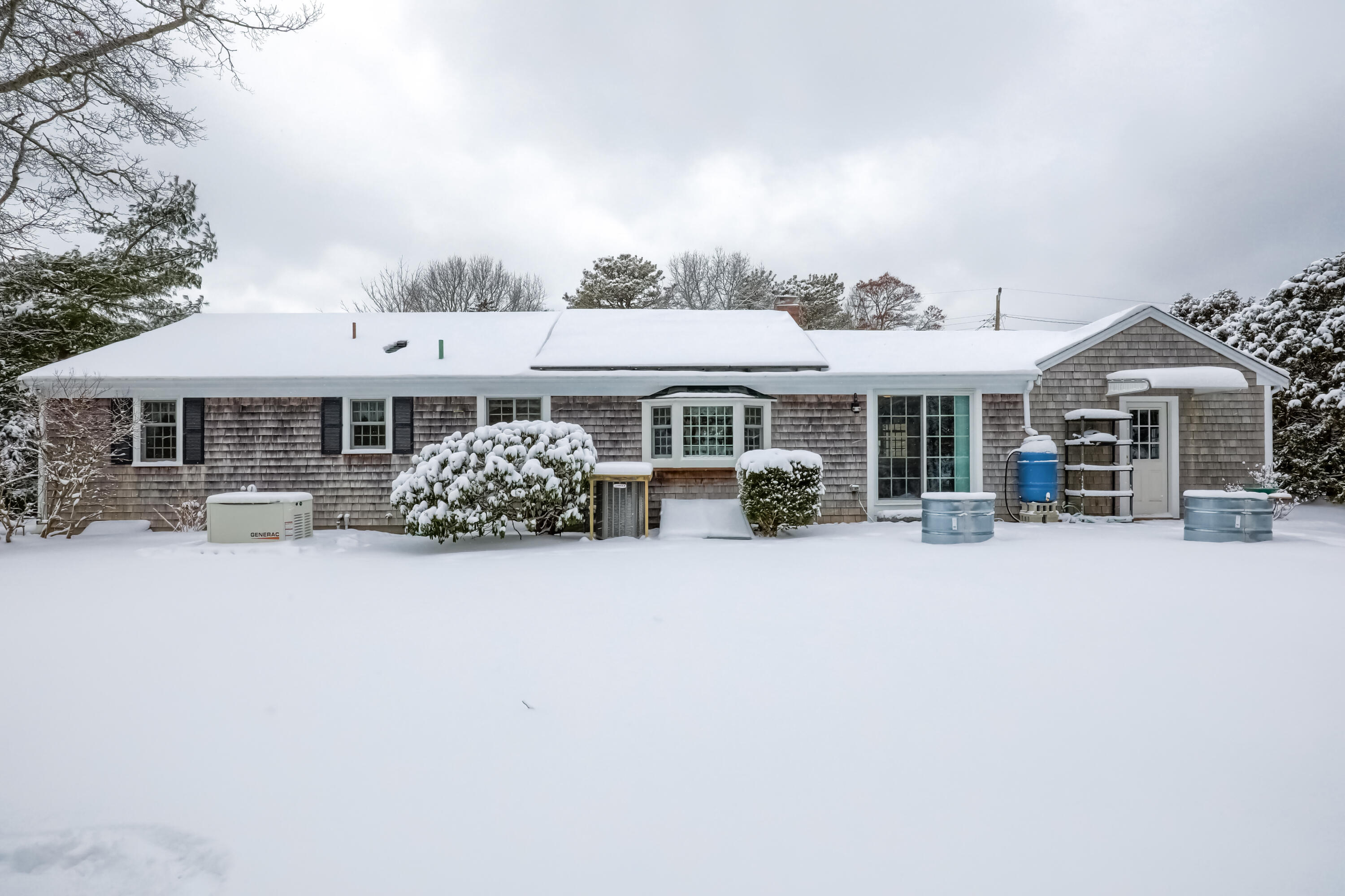 9 Captain Chase Road South Yarmouth, MA 02664 - Photo 24 of 28 a front view of a house with table and chairs