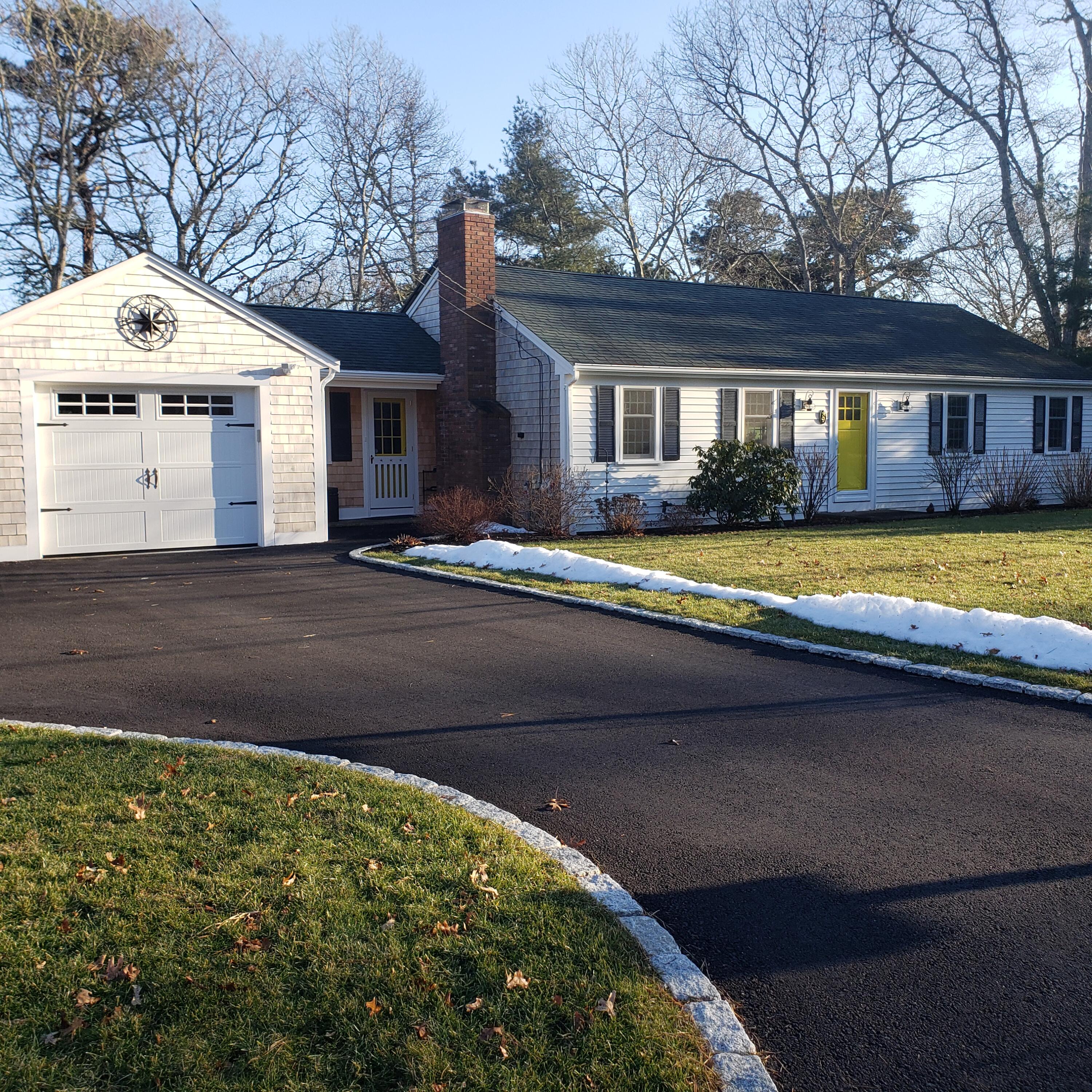 9 Captain Chase Road South Yarmouth, MA 02664 - Photo 25 of 28 a front view of a house with a yard and garage