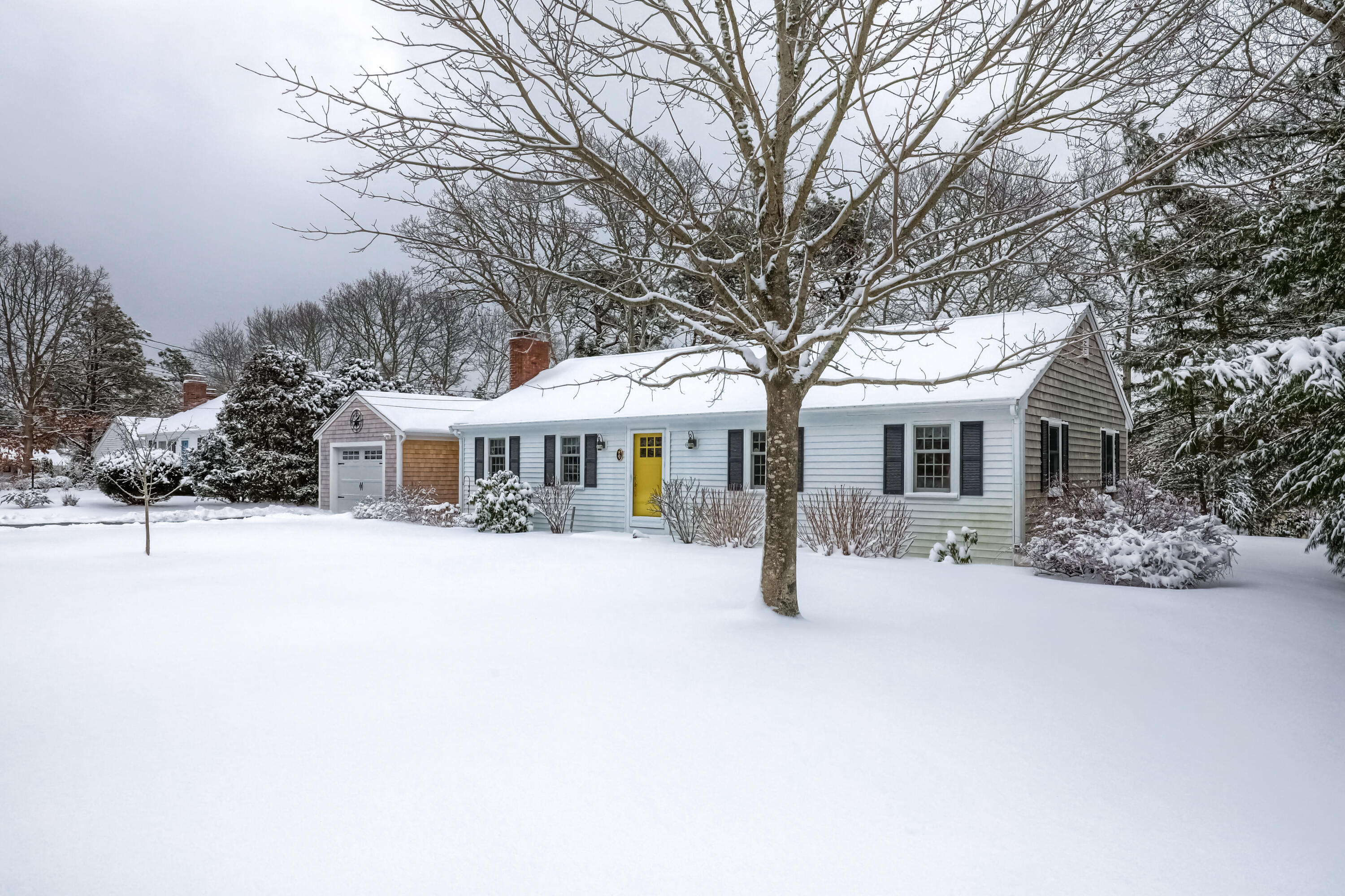 9 Captain Chase Road South Yarmouth, MA 02664 - Photo 3 of 28 a front view of a house with yard covered in snow
