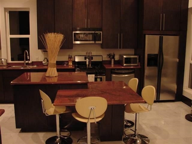 315 Lake Powell Laredo, TX 78041 - Photo 4 of 9 a kitchen with stainless steel appliances granite countertop a sink a microwave refrigerator and chairs