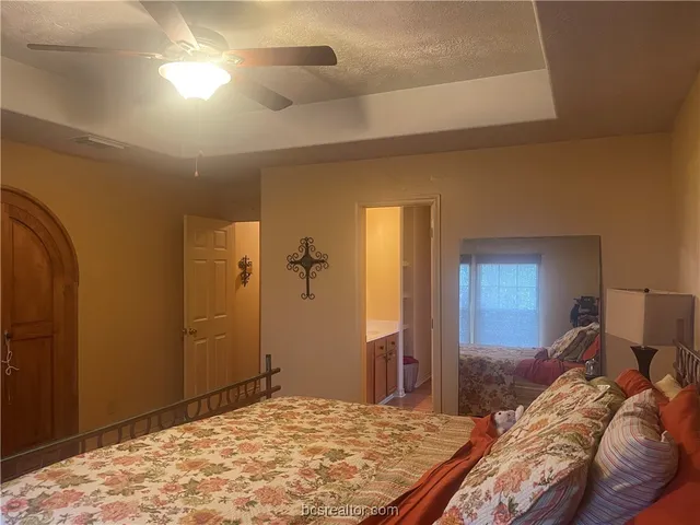 a bedroom with a bed and a dresser