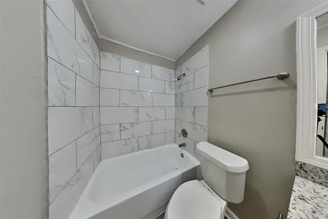 a bathroom with a toilet and bathtub