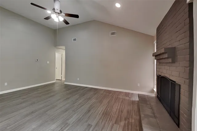wooden floor in an empty room with a fireplace