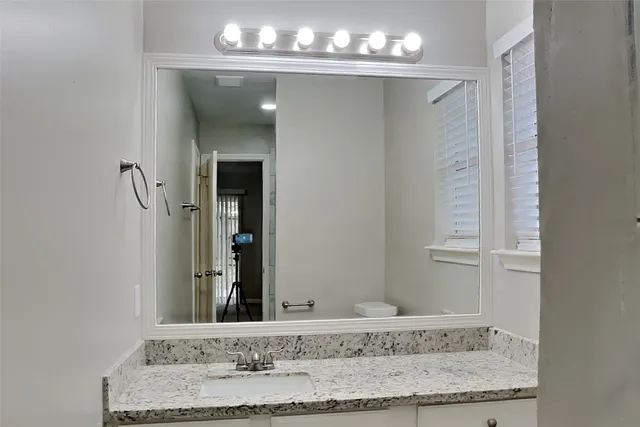a bathroom with a sink and a mirror