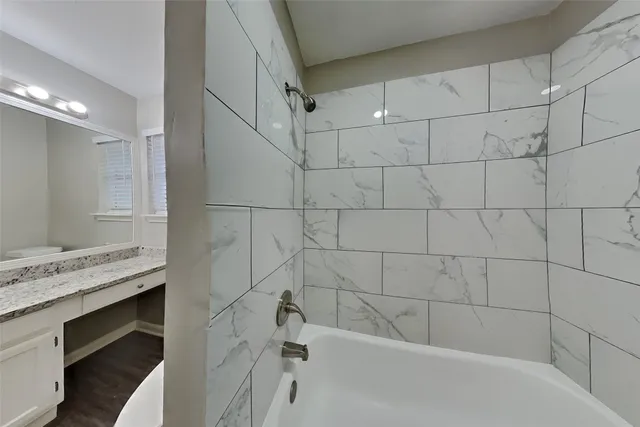 a bathroom with a bathtub and a sink