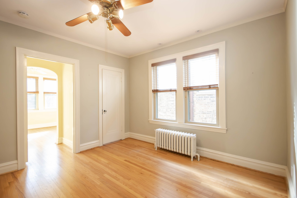 1122 Hull Terrace, Unit 2 Evanston, IL 60202 - Photo 11 of 17 a view of an empty room with wooden floor and a window