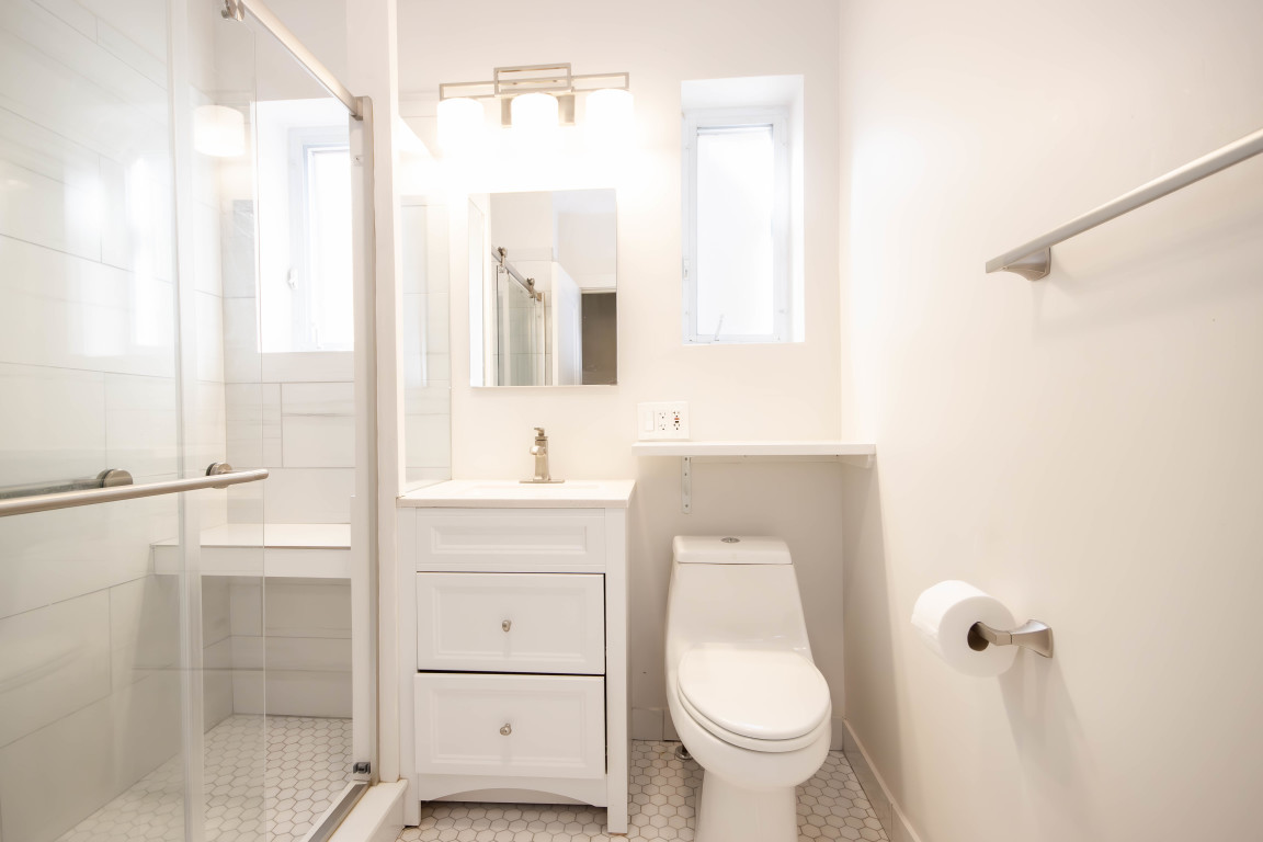 1122 Hull Terrace, Unit 2 Evanston, IL 60202 - Photo 13 of 17 a bathroom with a sink a toilet and shower