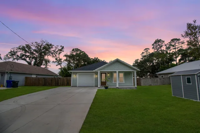 a front view of a house with a garden