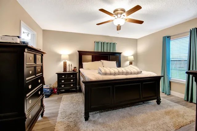 a bedroom with a bed and a chandelier