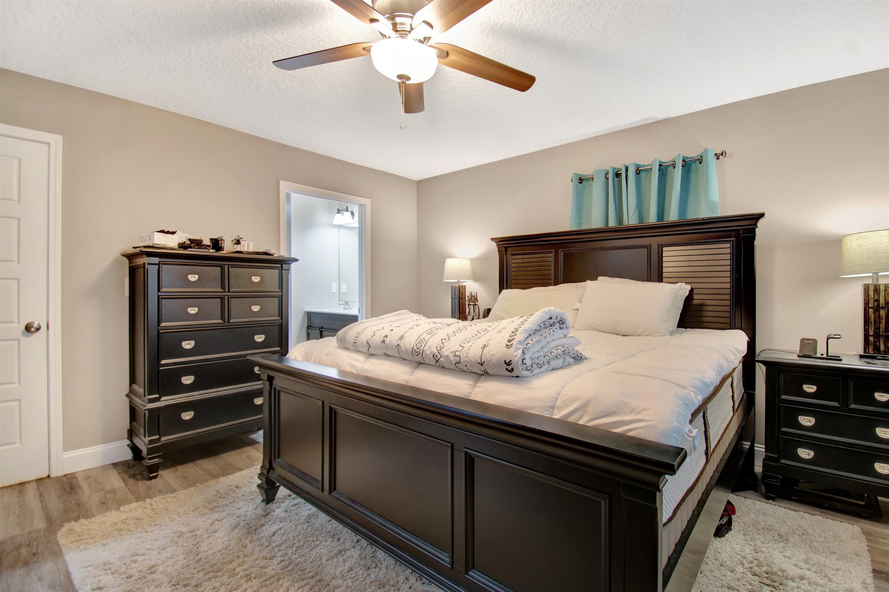5831 Oak Street Elkton, FL 32033 - Photo 16 of 22 a bedroom with a bed and a chandelier