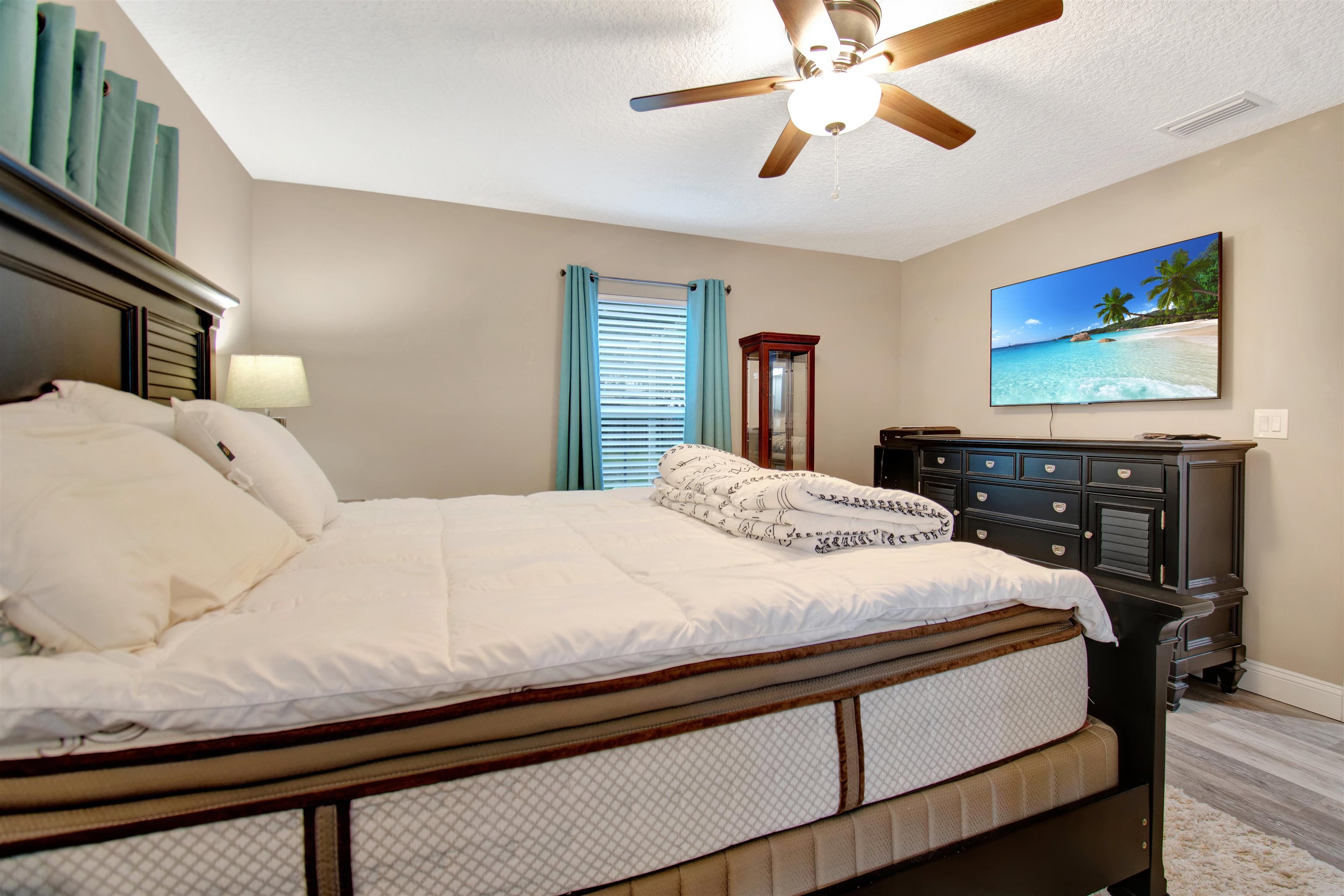 5831 Oak Street Elkton, FL 32033 - Photo 17 of 22 a bedroom with a bed and a chandelier
