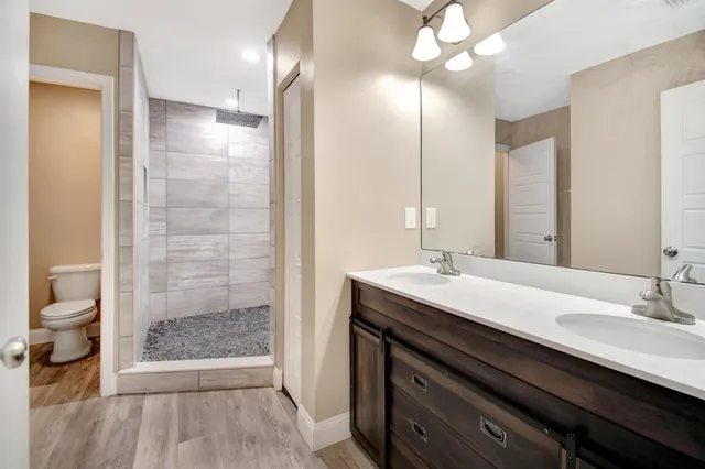 a bathroom with a sink double vanity and a shower