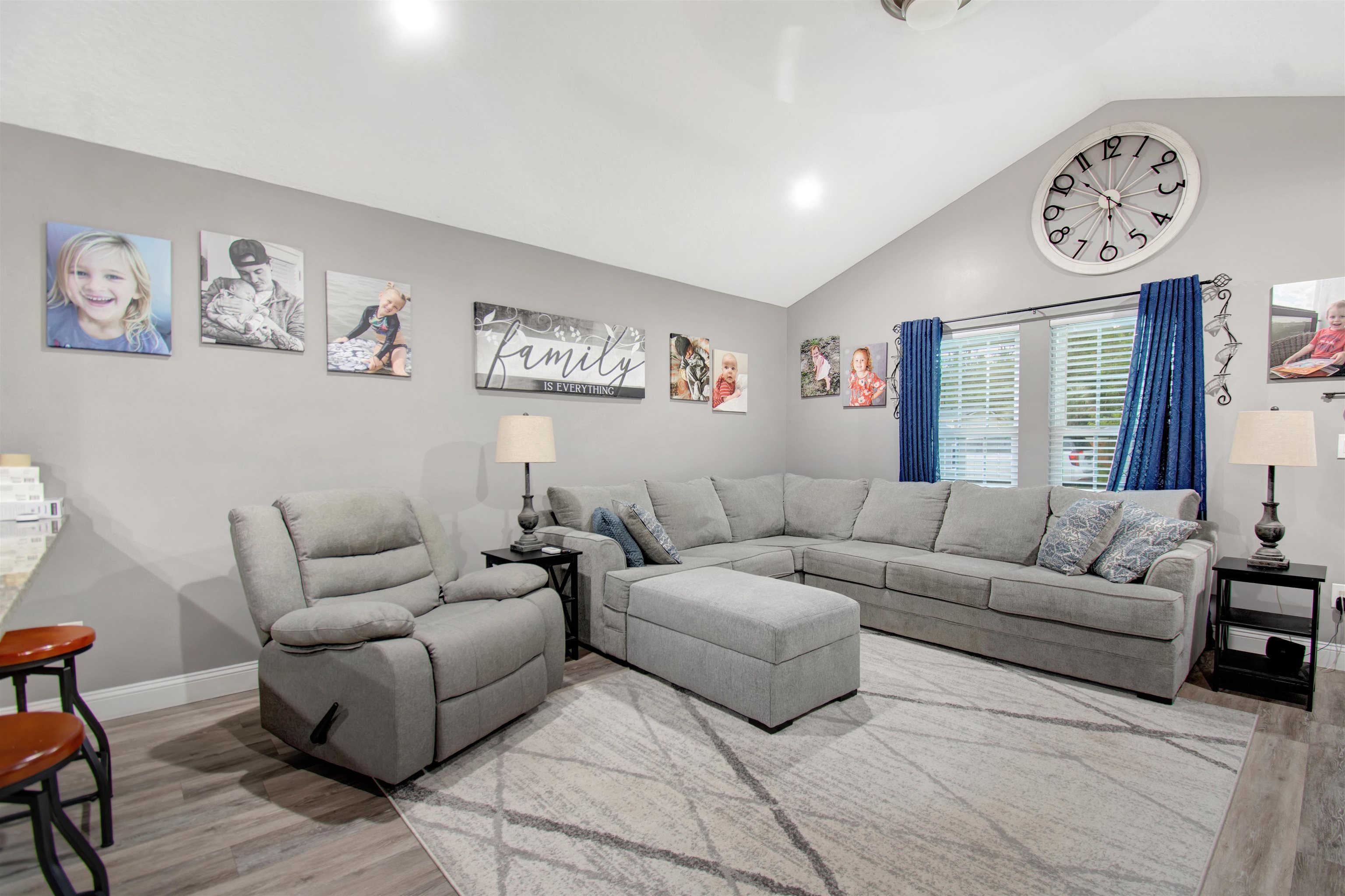 5831 Oak Street Elkton, FL 32033 - Photo 2 of 22 a living room with furniture a couch and paintings on the wall