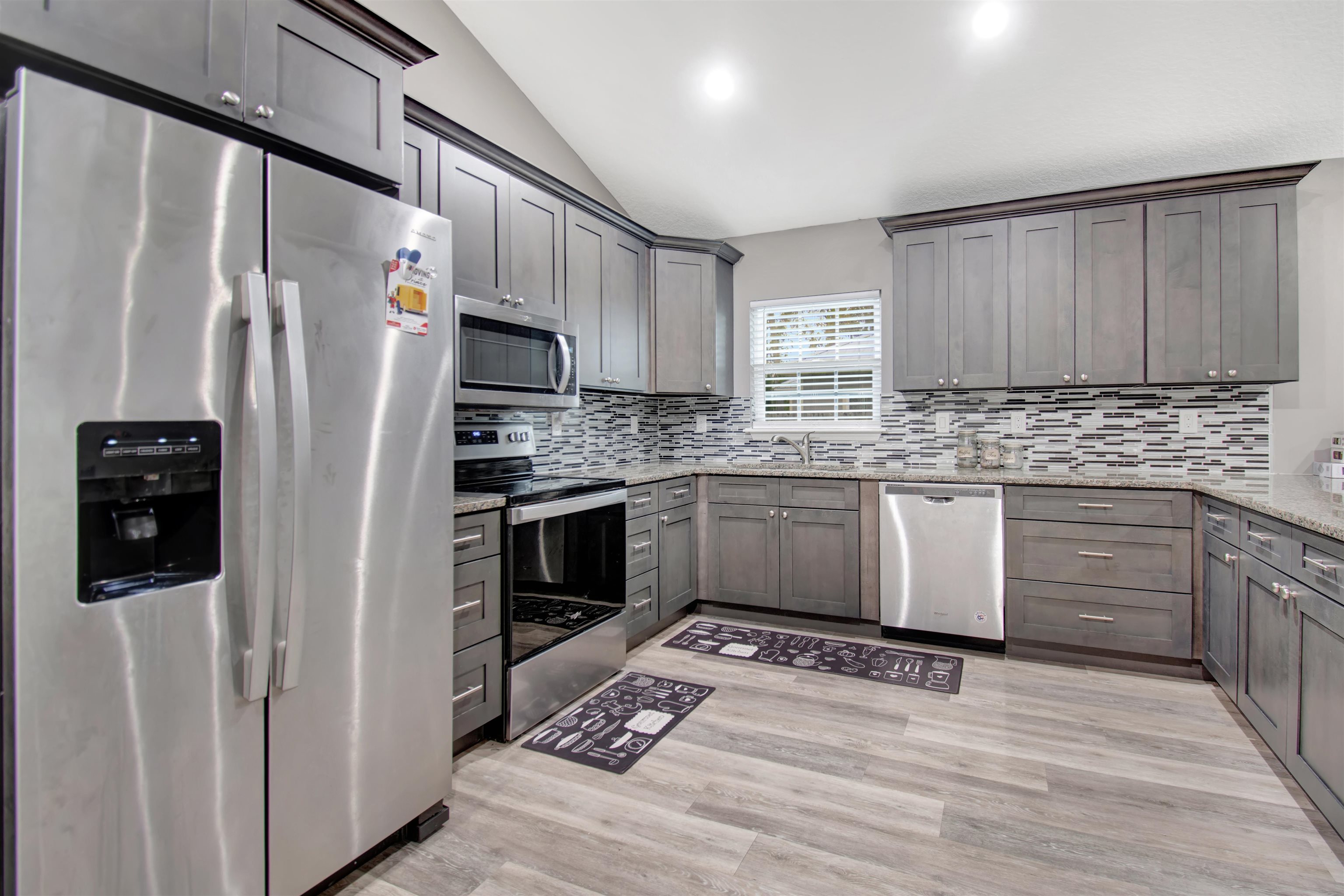 5831 Oak Street Elkton, FL 32033 - Photo 5 of 22 a kitchen with stainless steel appliances a stove a sink and a refrigerator