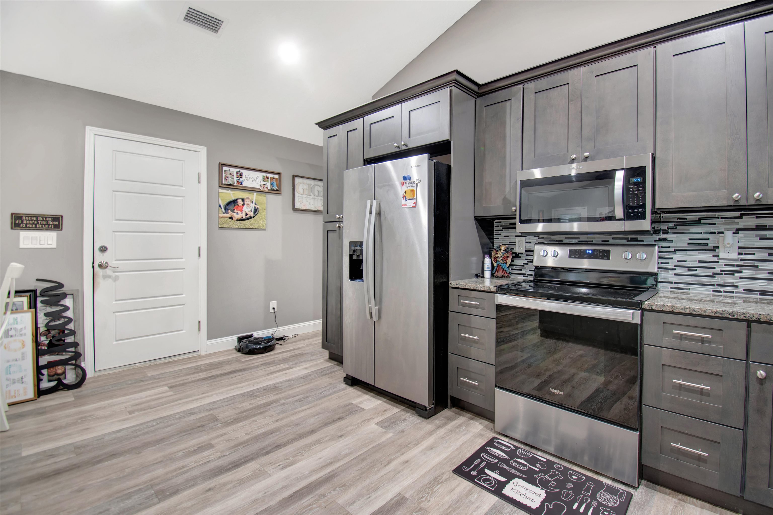 5831 Oak Street Elkton, FL 32033 - Photo 6 of 22 a kitchen with granite countertop a refrigerator stove and microwave