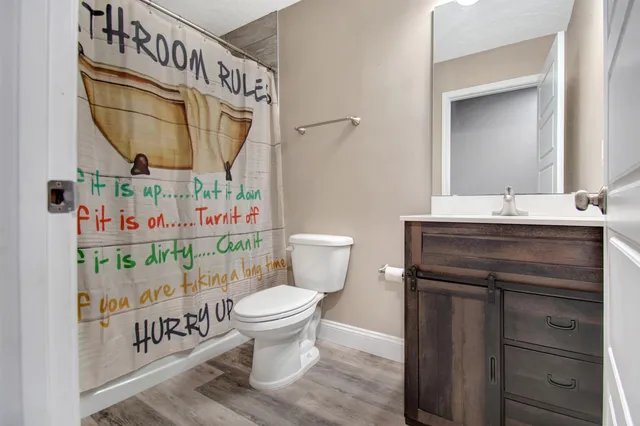 a bathroom with a sink a toilet and a mirror