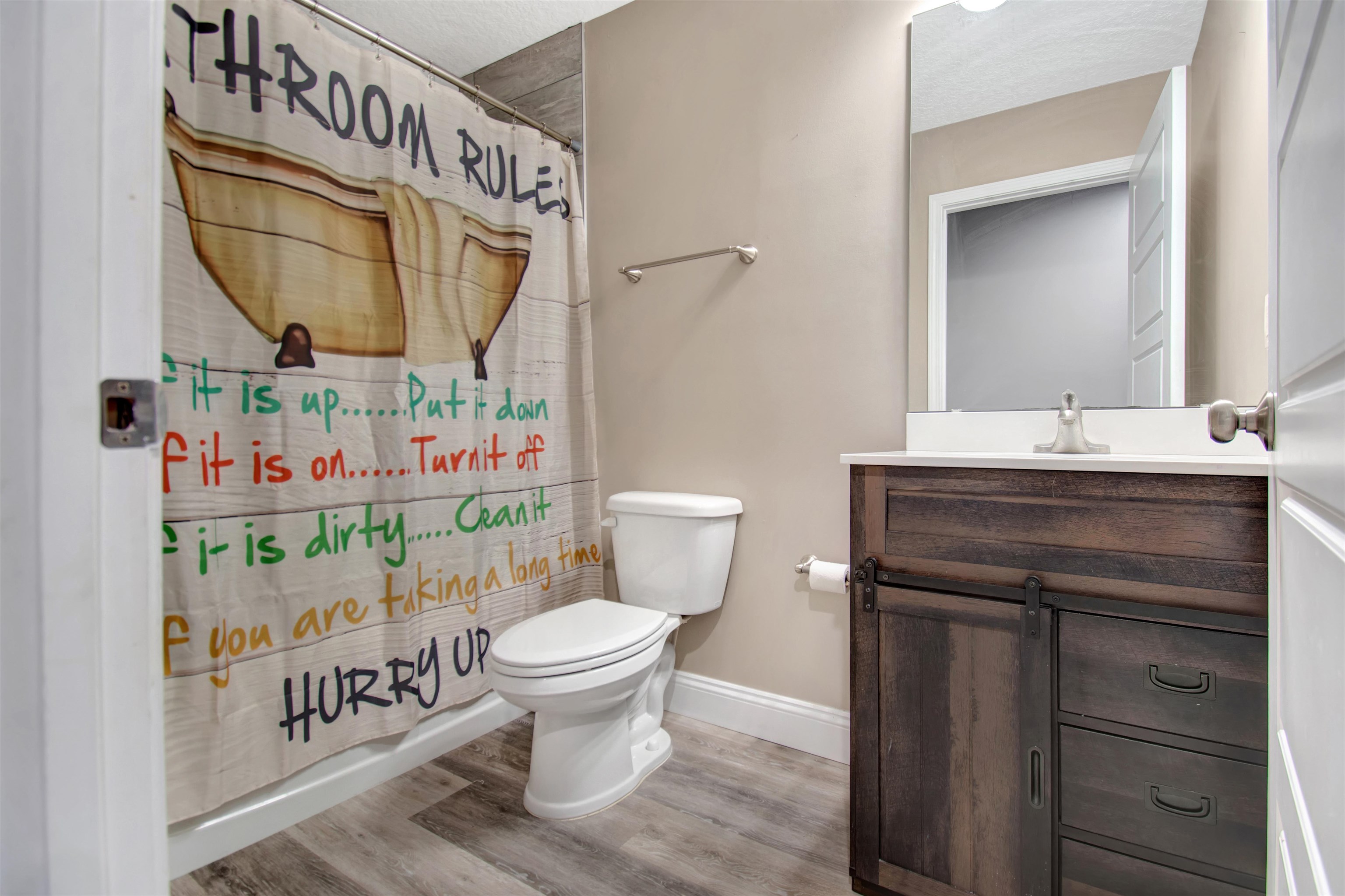 5831 Oak Street Elkton, FL 32033 - Photo 10 of 22 a bathroom with a sink a toilet and a mirror