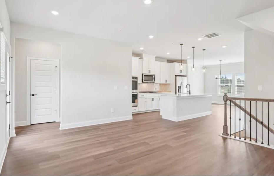 6390 Pinin Place Cumming, GA 30041 - Photo 9 of 14 a view of kitchen with wooden floor