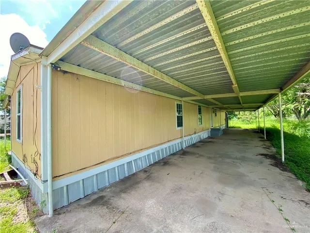 a view of a house with a backyard
