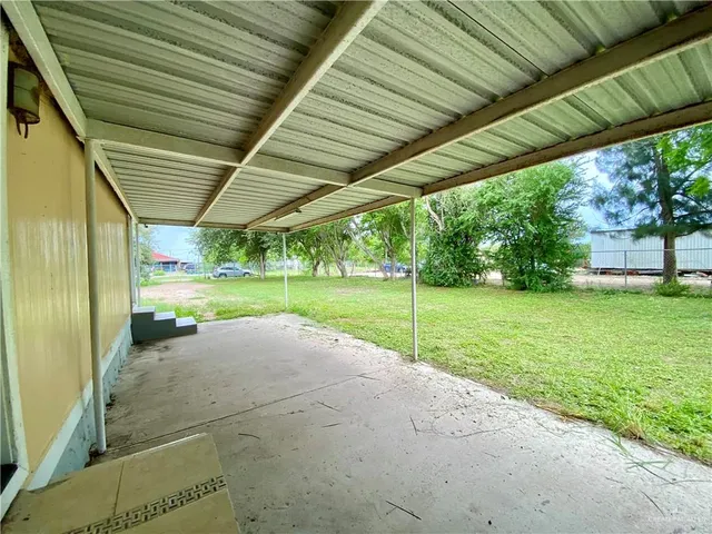 a house with green field in front of it