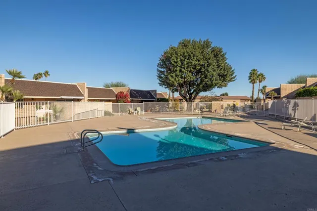 an outdoor space with pool table and chairs