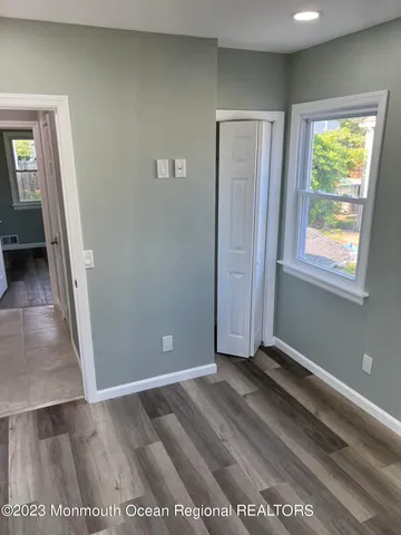an empty room with windows and closet