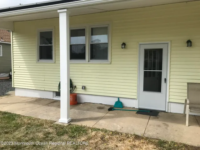 a side view of a house with a yard