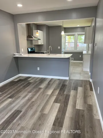 a view of a living room a bathroom with a sink and mirror