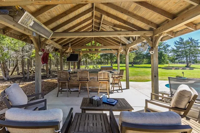 a view of living room with patio furniture and garden view