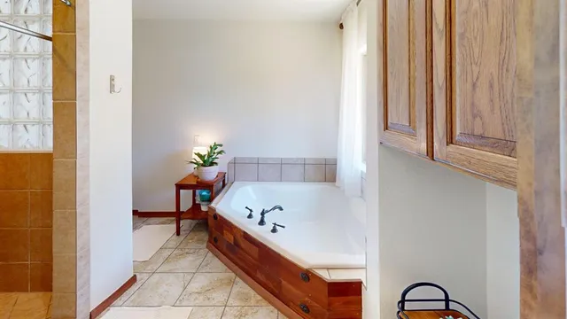 a bath room with a bathtub and a window