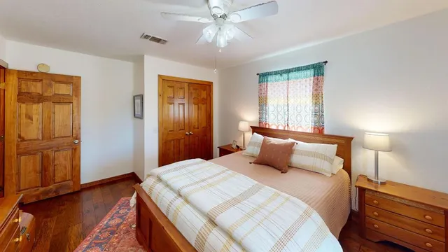 a bedroom with a bed and wooden floor