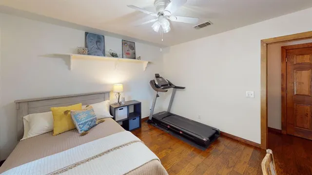 a bedroom with furniture and a wooden floor