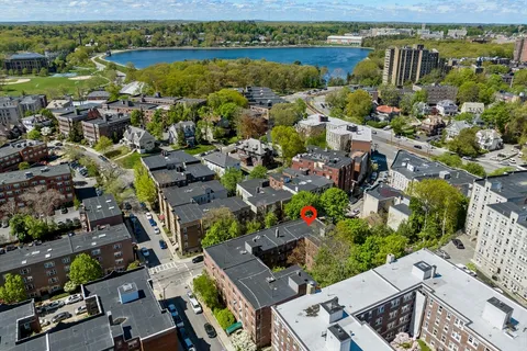an aerial view of residential building with outdoor space and lake view