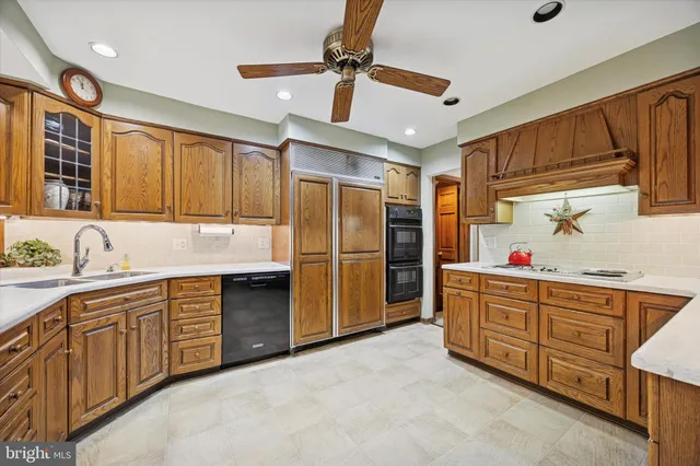 a kitchen with stainless steel appliances granite countertop a refrigerator and a stove