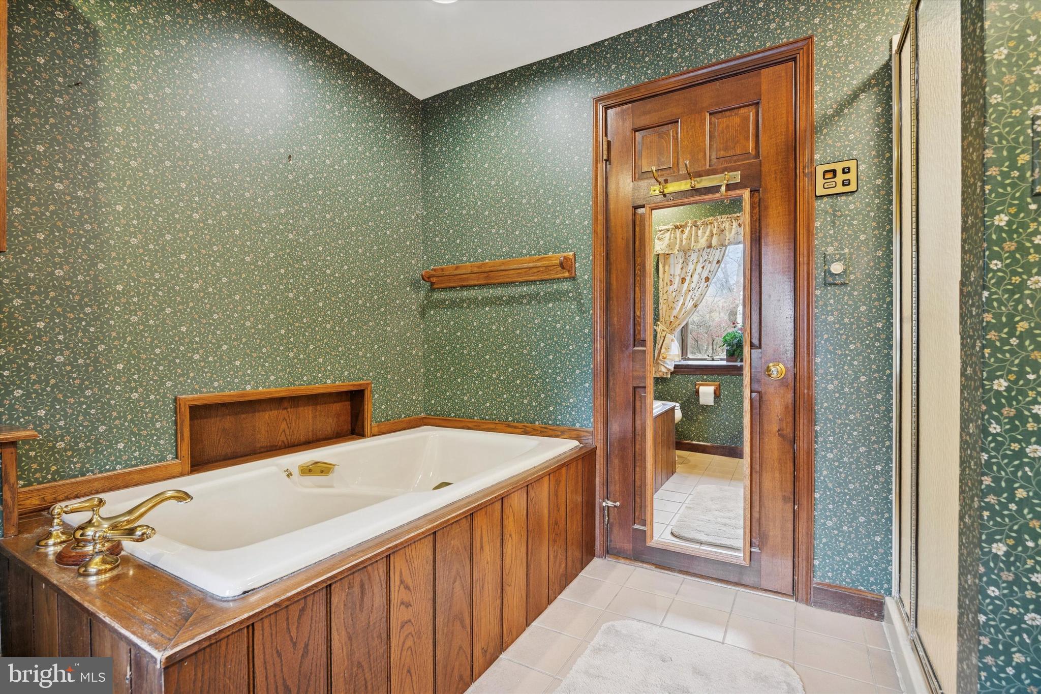 1162 Limekiln Pike Ambler, PA 19002 - Photo 29 of 56 a bathroom with a sink a mirror and a bathtub
